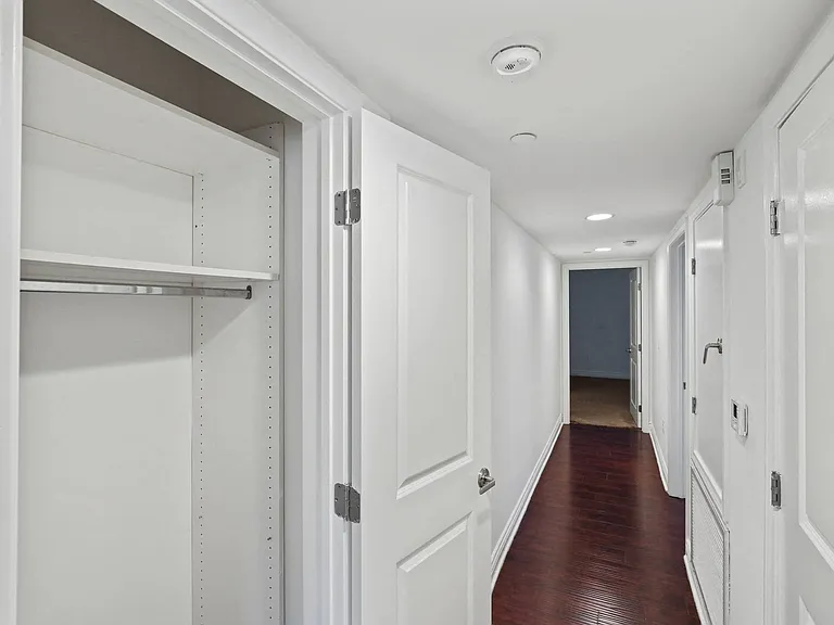 Hallway with Storage Closet and Vinyl Flooring