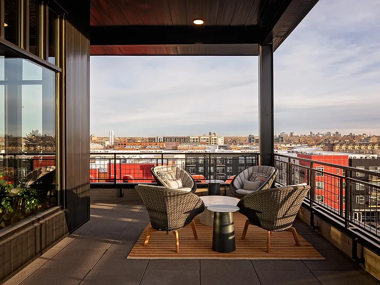 Rooftop lounge featuring ample social spaces