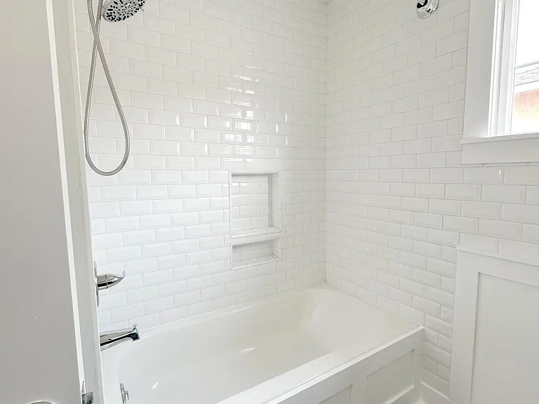 Front bathroom, updated vanity, shower/tub combo, subway tile, toilet