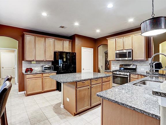 Fabulous island kitchen/breakfast room with excellent storage and acres of granite counter space. Gas stove and large pantry.