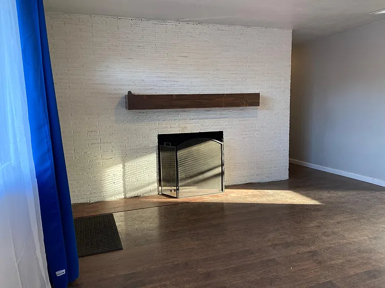 Fire Place on the south side of the living room. With hallway leading to three bedrooms and bathroom