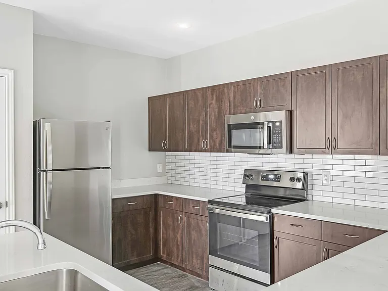 Upgraded kitchens include ENERGY STAR_ stainless steel appliances, quartz countertops, and stylish tile backsplash.