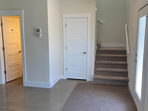 Entrance, coat closet, powder room, and stairs to the second floor