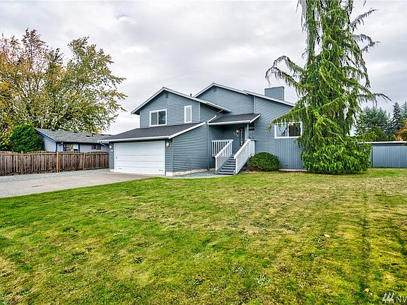 This house stands out with great curb appeal, and a beautiful Alaskan Cedar tree!