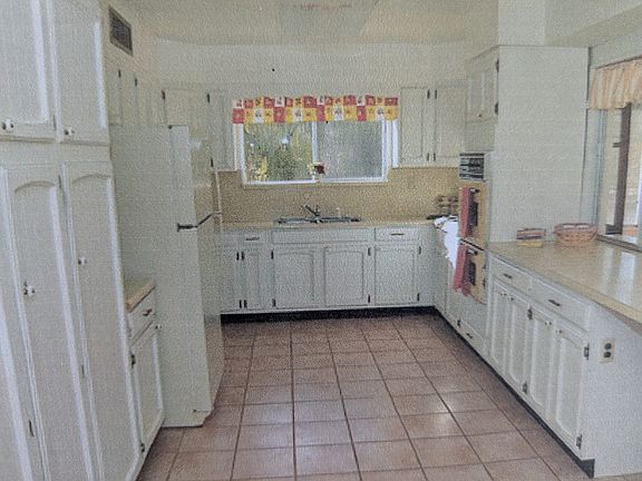 Spacious kitchen with breakfast bar adjoining the formal dining area