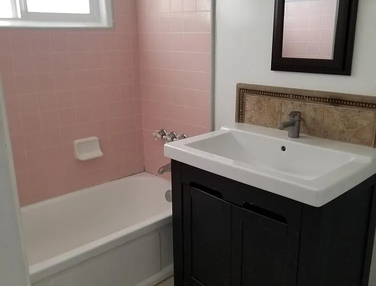 Master bathroom with vintage pink and gray shower tile circa 1957.