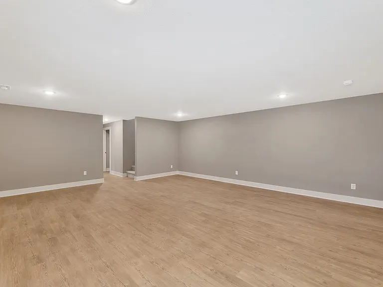rec room in basement view to bedroom and bathroom area