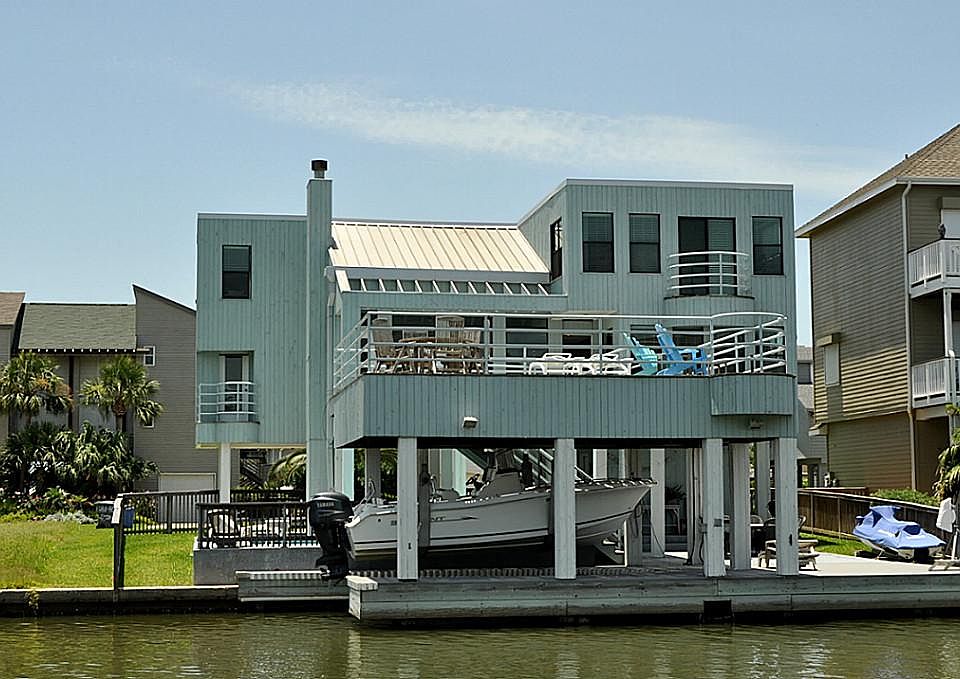 Canal side of this contemporary designed exterior with Firestone TPO 6 year old roof. This is the 2n