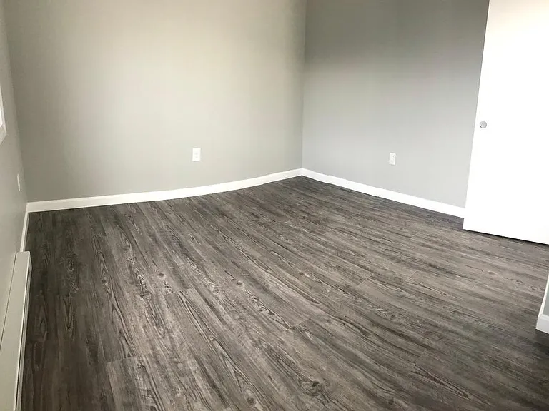 Second bedroom, offers updated flooring, paint, large window and closet.