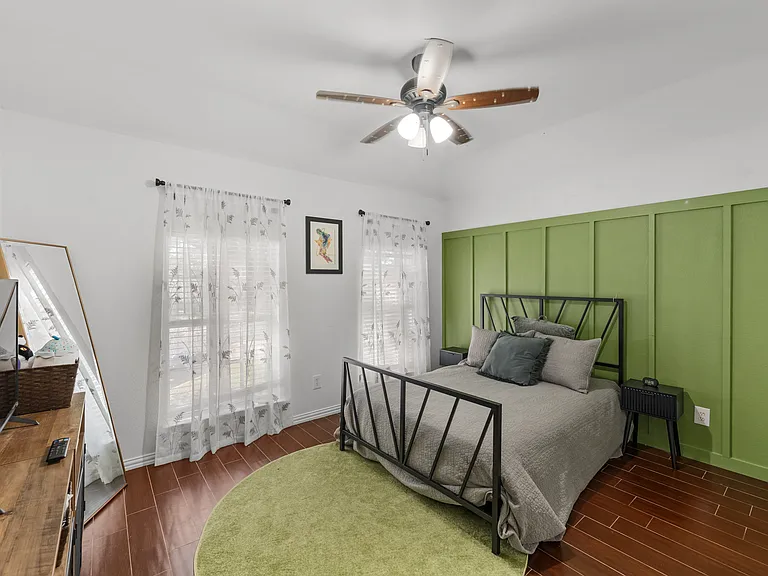 Relaxing queen room with a soft, comfy feel and a TV.