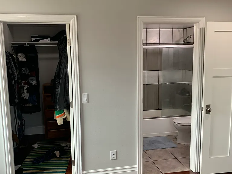 Primary Bedroom: Left door is walk in closet. Right door is ensuite bathroom