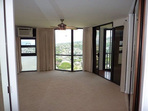 Master Bedroom With Window AC And Ceiling Fan