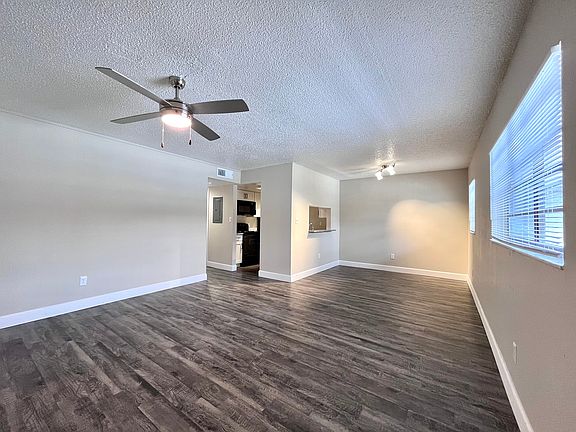 Experience comfort in this airy living space with modern flooring and ample natural light.