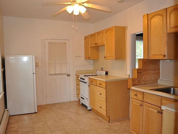 Kitchen showing entry door from back staircase.