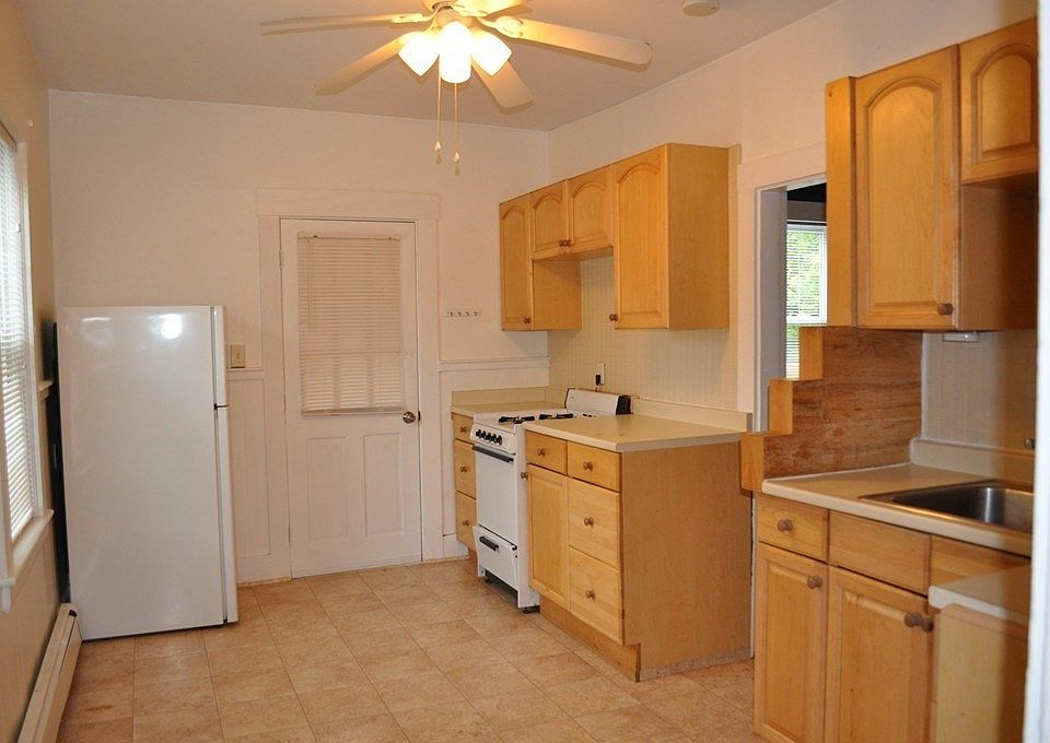Kitchen showing entry door from back staircase.