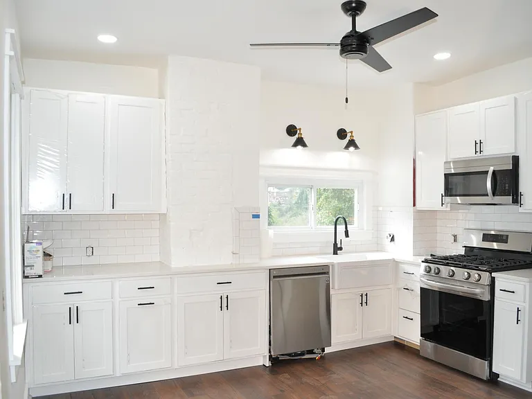 Kitchen with new cabinets, quartz countertop and stainless steel appliances.