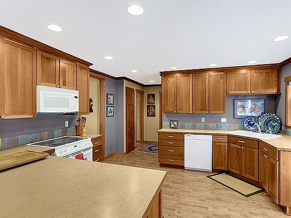 Abundant Cabinetry in Cherry, Open to the Great room w/ counter seating. Large outdoor entertainment deck off of kitchen enjoy pastoral views.