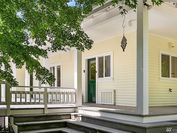 Generous, welcoming porch with covered and open spaces. Trex decking. Green door in center leads into kitchen.