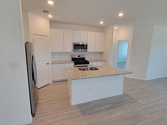 Spacious kitchen with the sink and dishwasher on the island