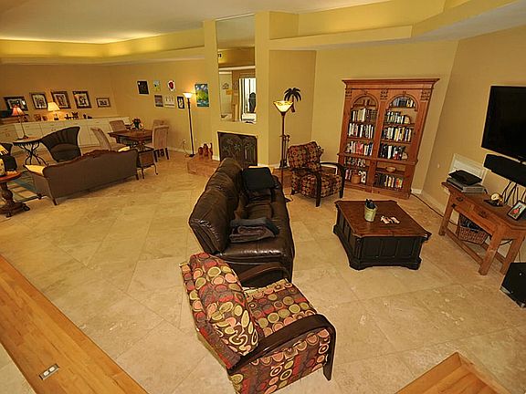 This multi-functional room measures 25 x 44. The owners currently have it configured as a den, forma