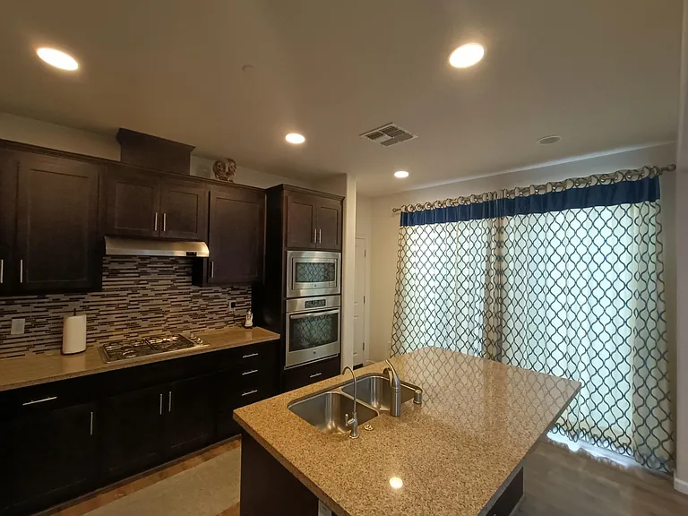 Step into a cozy kitchen retreat with ceiling lights aglow and the knook door curtains gently closed. The perfect ambiance for culinary adventures, where style meets functionality in every detail. Your culinary sanctuary, beautifully illuminated. _____