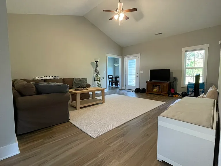 Living room with view from foyer towards dining area