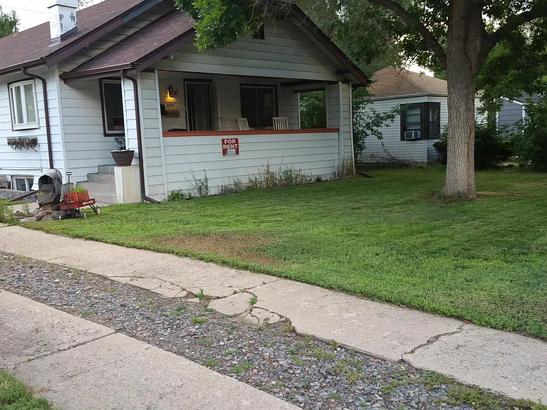 Exterior of home. Basement is the available unit. Yard and landscape maintained by property managers.