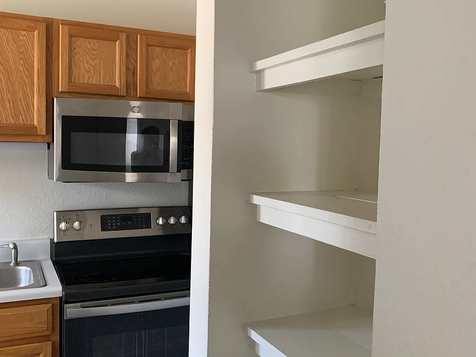 Large pantry shelf and stainless steel appliances!