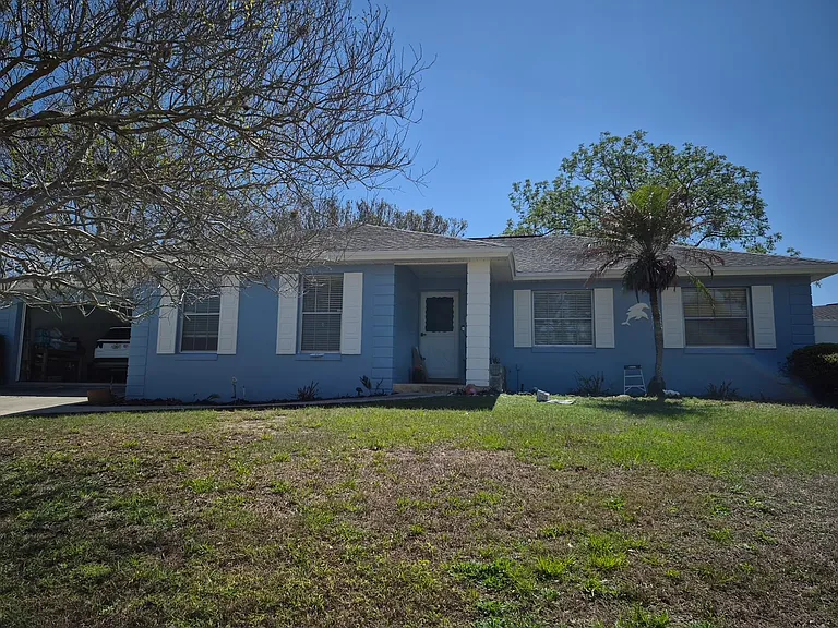 Front of house from street. Private entrance in back behind fence