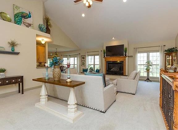 A stunning, vaulted living area greets you immediately, washed in natural light and warmed by a gas 
