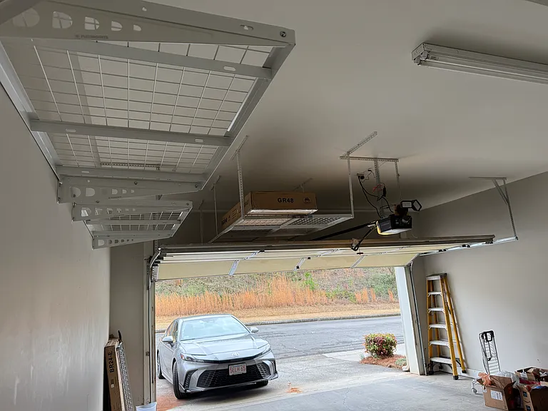 Large two car garage with plenty of rack and overhead storage.