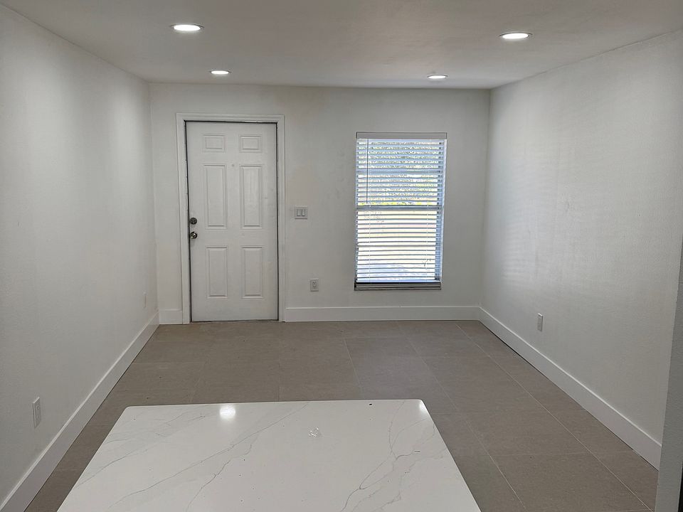 View from kitchen of front door and family room