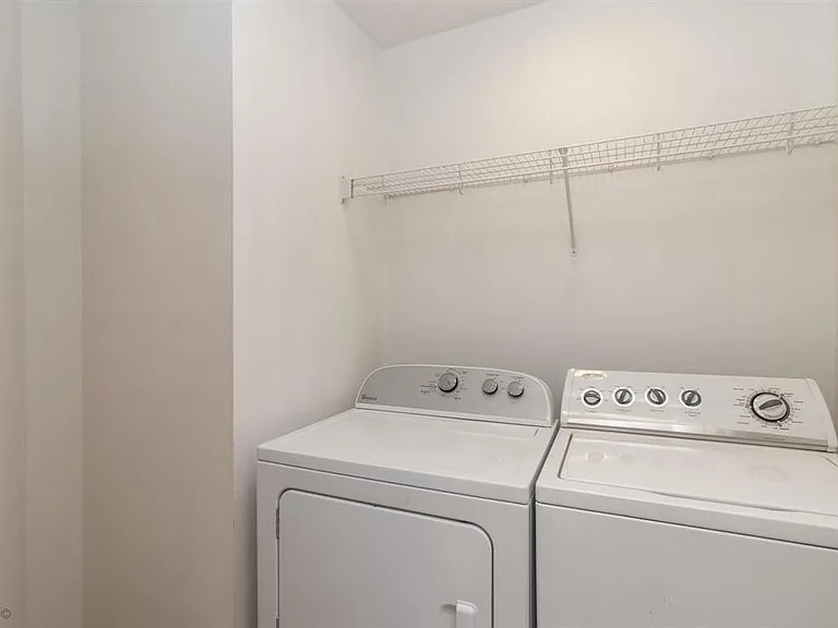 Laundry room upstairs by bedrooms.