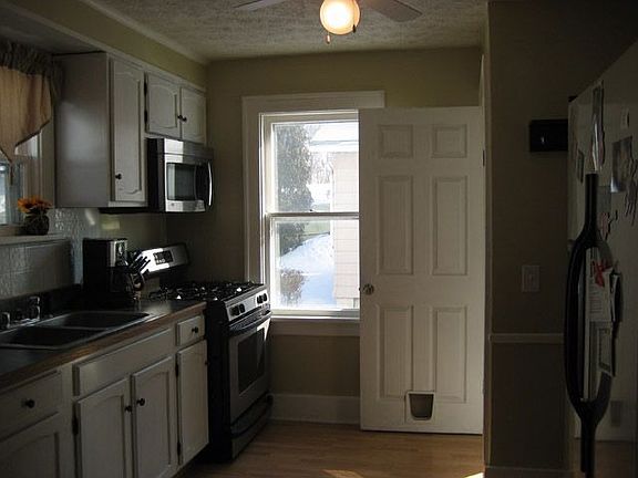 Other view of updated kitchen with new appliances & ceiling fan