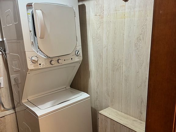 Less than one year old stackable washer and dryer in walk-in closet.