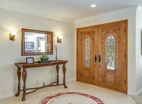 Travertine floors in the entry and double entry doors with leade