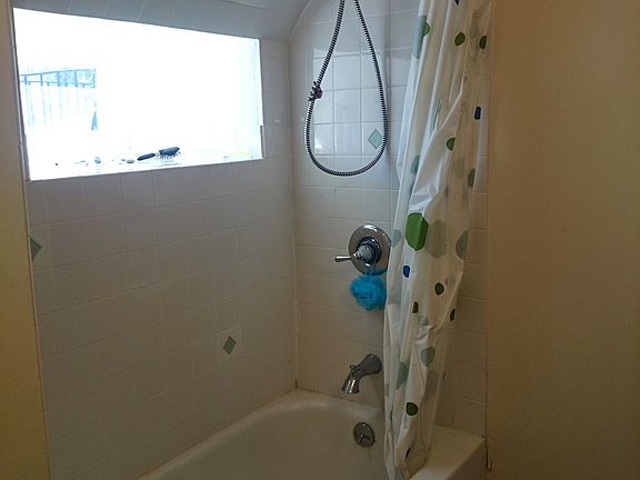 bathroom with window and bathtub