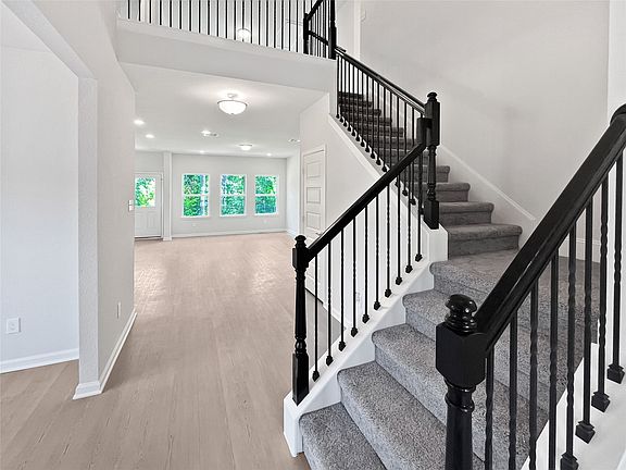 The Princeton II- Staircase with Wrought Iron Railing.