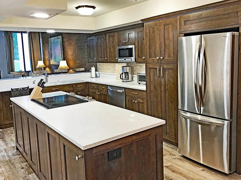 The spacious kitchen island is perfect for unpacking groceries into the pantry or refrigerator, or to place food buffet style when entertaining.