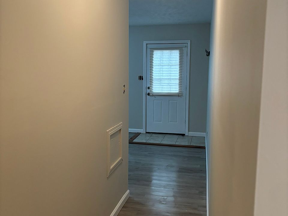 Front door to hallway leading to kitchen.