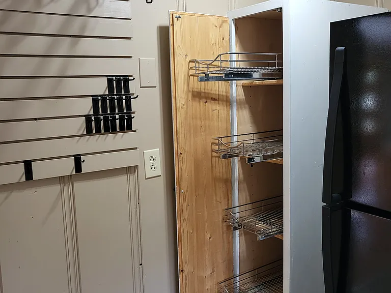 built in pantry with 5 sliding shelves.