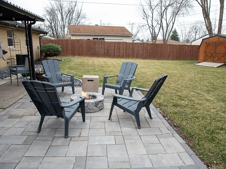 Your private backyard oasis, featuring a hot tub, stone patio, and plenty of space to relax.