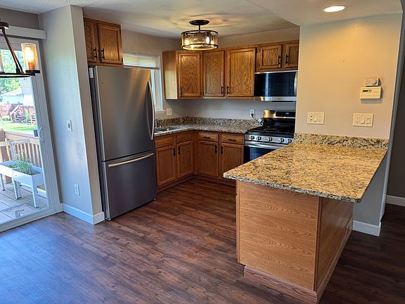 Updated kitchen with brand new stainless steel appliances, granite counter tops, light fixtures, and vinyl flooring.
