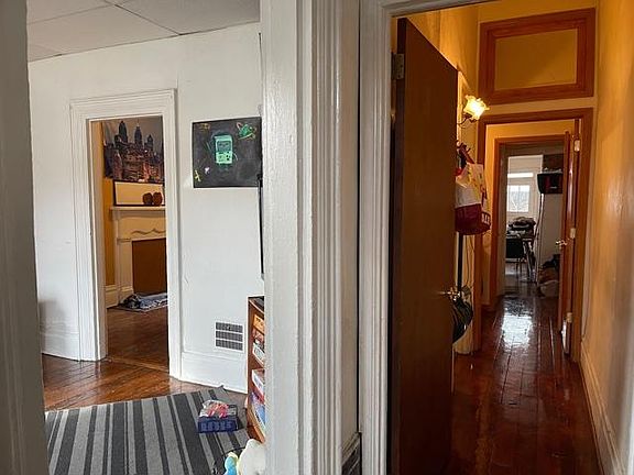The Entry Hall continues to the right - straight back thru a Double-Door Half Bath, into the Kitchen . To the left are the LivingRoom, DiningRoom, & also Kitchen . Let's see the Half Bath first, and then the rest of the house .