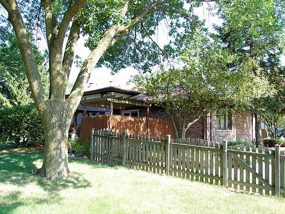 Large fenced yard with mature trees