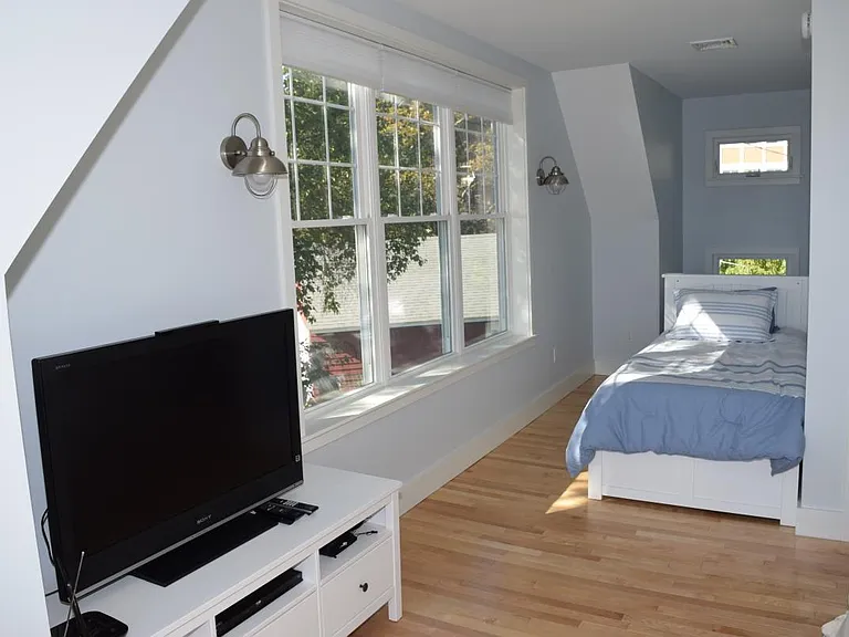 Large room with couch, tv, 2 extra large twin beds and incre