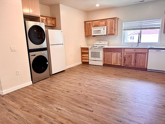 From the living room, you walk down a hall to the kitchen with brand new floors & beautiful solid wood cabinets