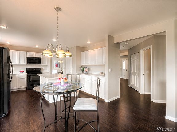 New updated kitchen with wood floors, Quartz counters and stainless steel charcoal appliances. 