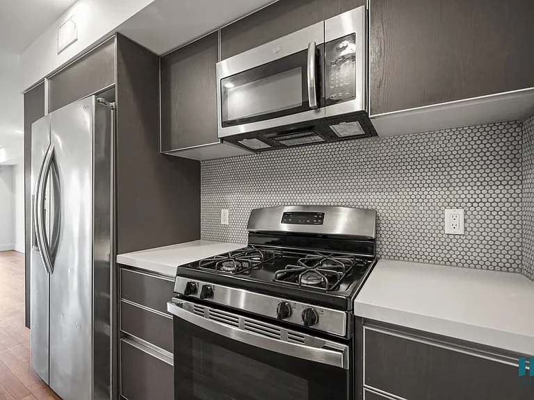 Kitchen with Stainless-Steel Refrigerator, Stove, and Microwave Oven