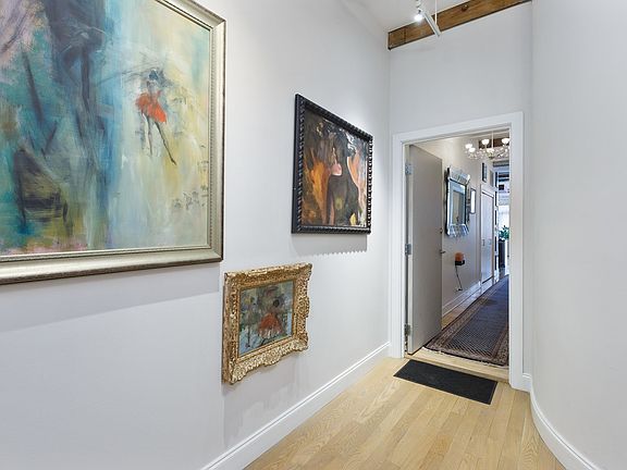 A SECURED ELEVATOR BRINGS YOU TO LEVEL 4. THE COMMON FOYER IS BRIGHT.  ARTWORK TRULY REFLECTS THE GA